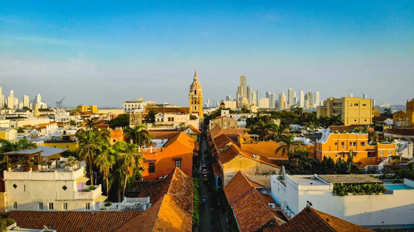 Aerial view of Cartagena's walled Old Town with red rooftops and Colombia's skyline behind