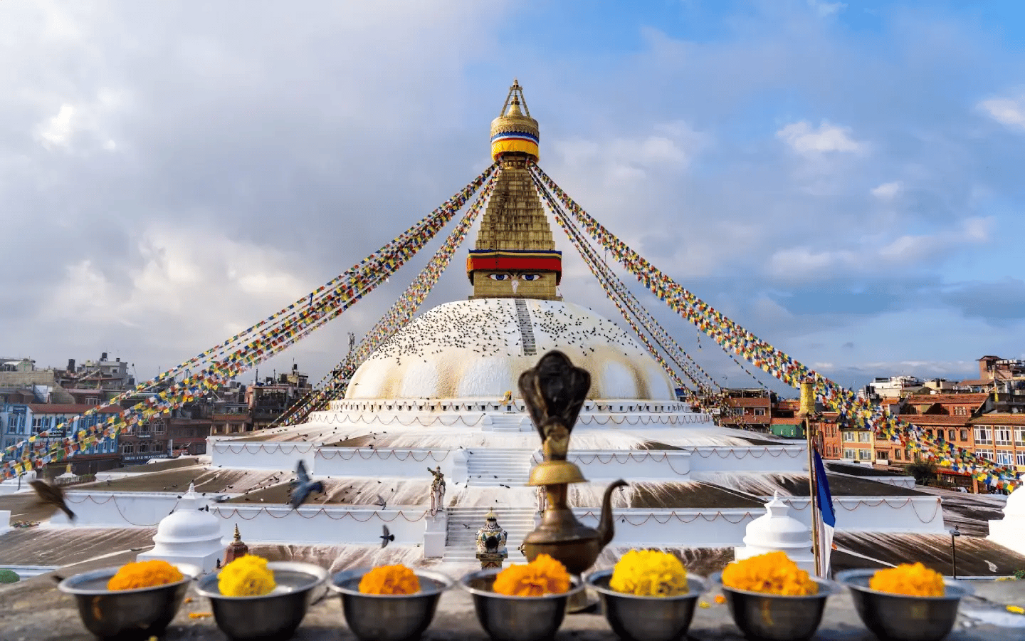 Boudhanath Stupa with its painted Buddha eyes and strings of prayer flags, Kathmandu, Nepal.
