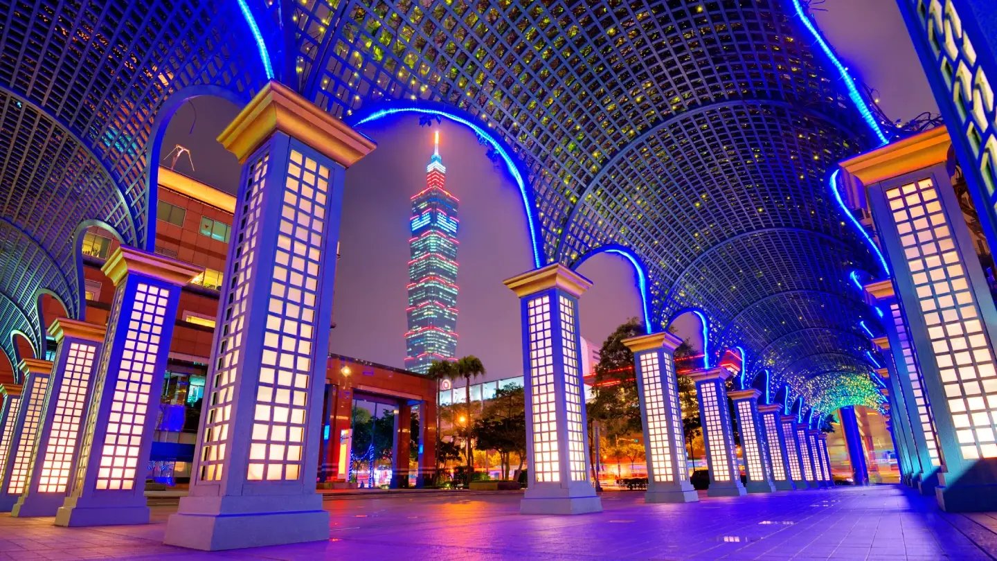 Illuminated archway installation framing a view of Taipei 101