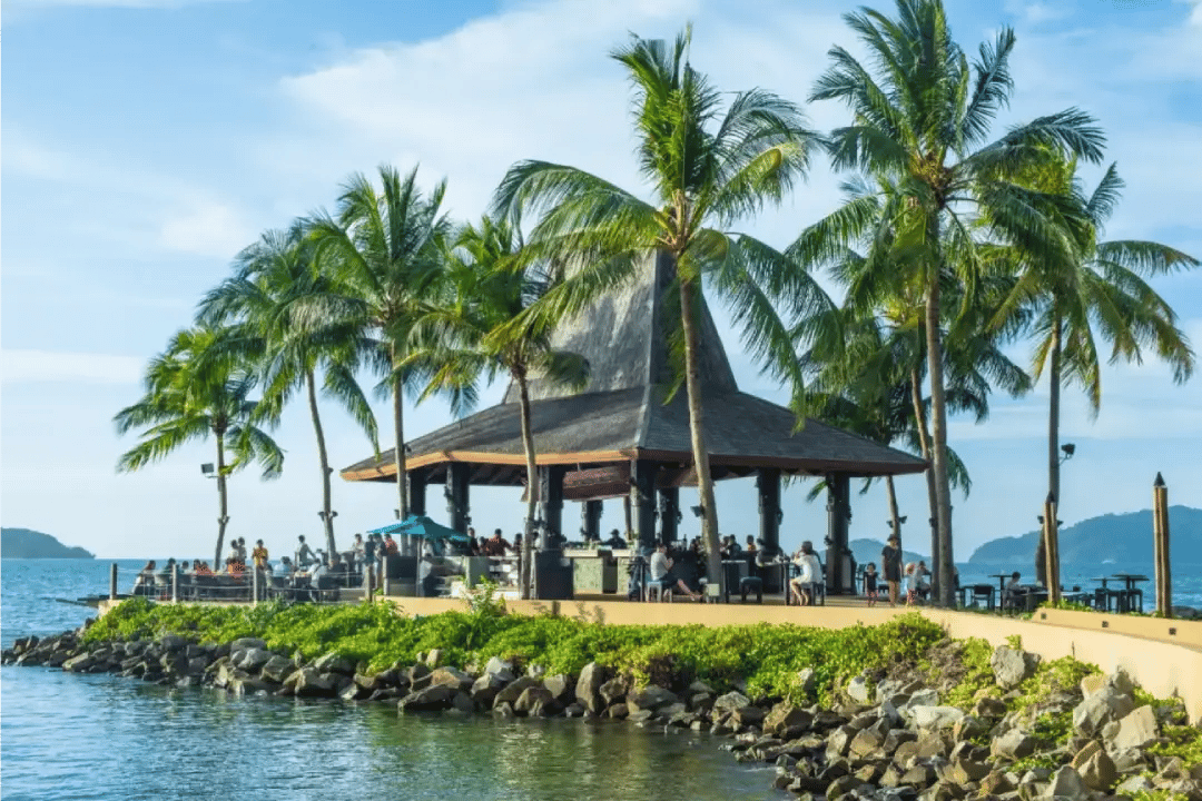 Cottage and coconut trees on the beach