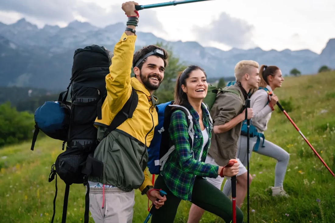 Group of hikers celebrating together on a mountain trail