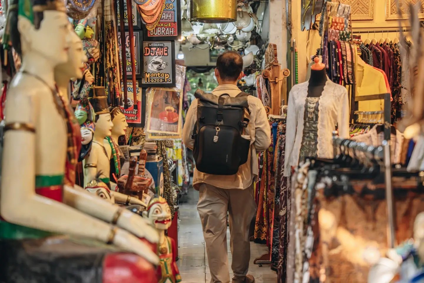A tourist with a backpack browsing shops in a busy market alley, Thamel, Kathmandu.