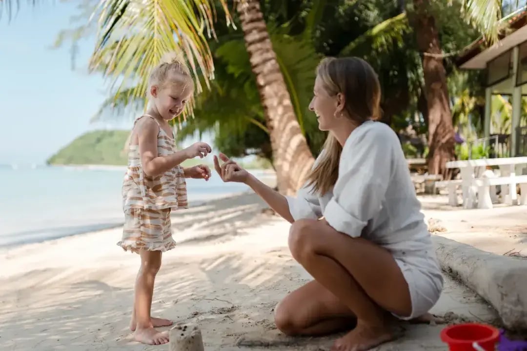 mother and daughter playing on the beach