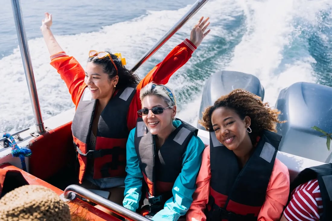 Friends laughing on a speedboat during a spontaneous day trip