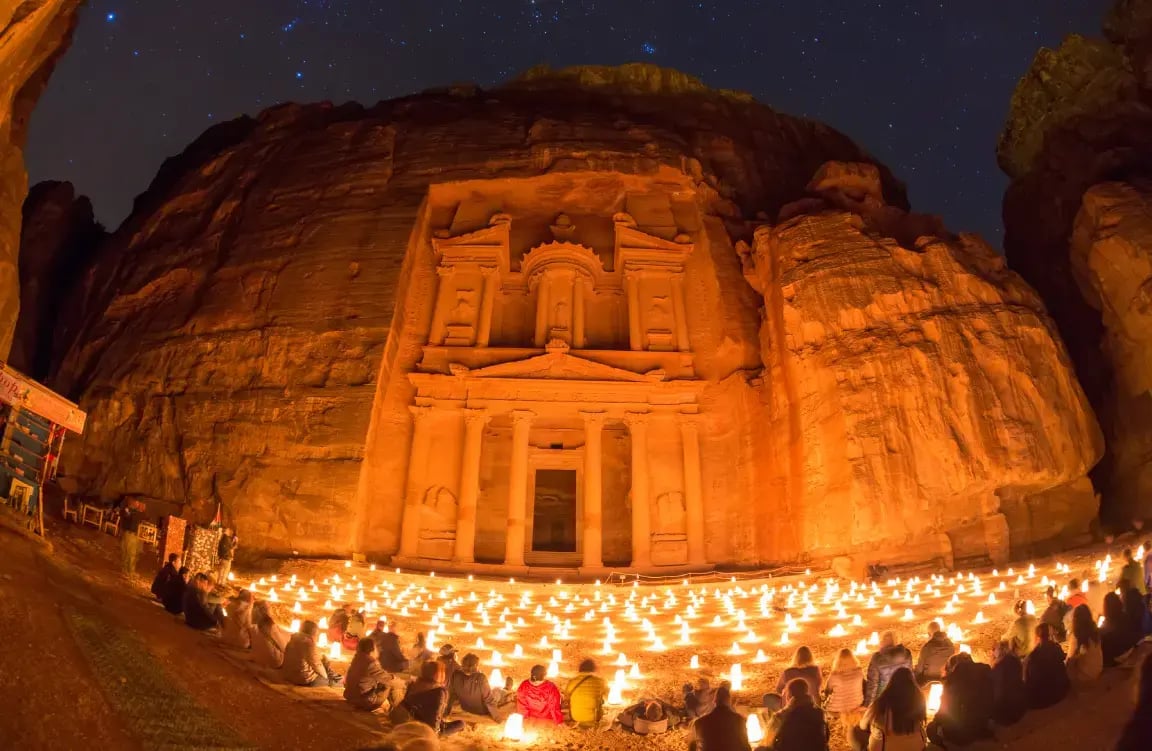 Petra's Treasury illuminated by hundreds of candles at night during Petra by Night