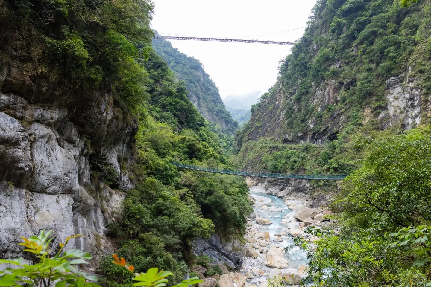 Marble cliffs and a footbridge over the river at Taroko Gorge