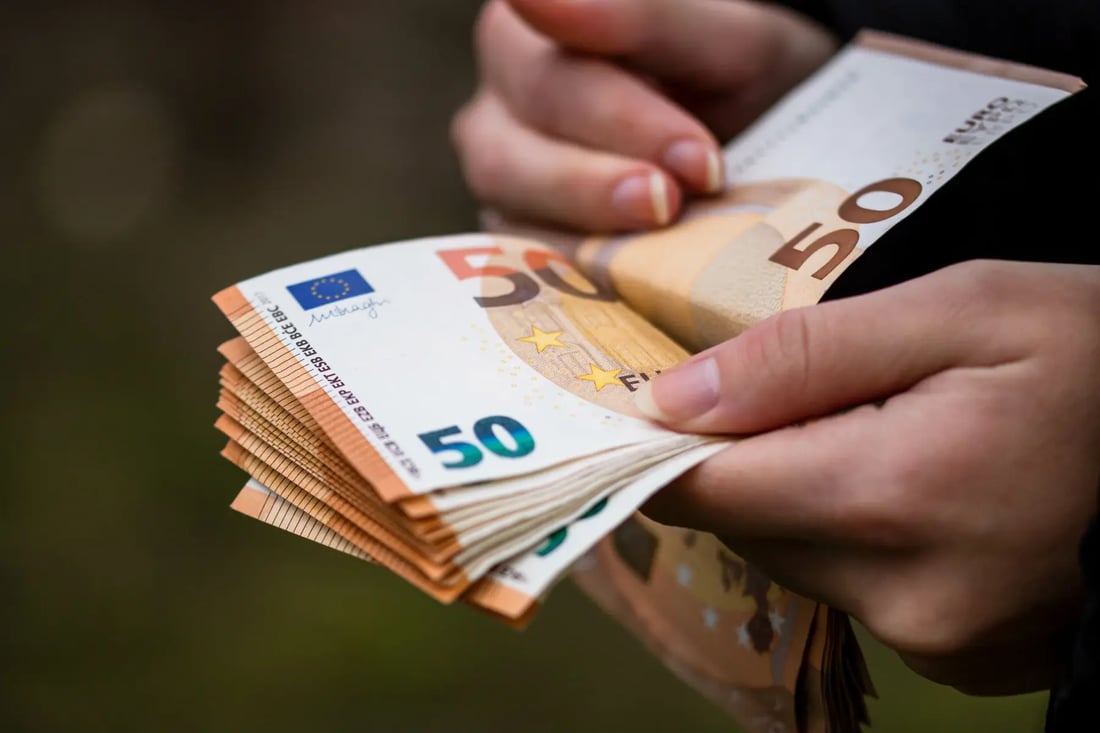 Close-up of traveller counting 50-euro banknotes
