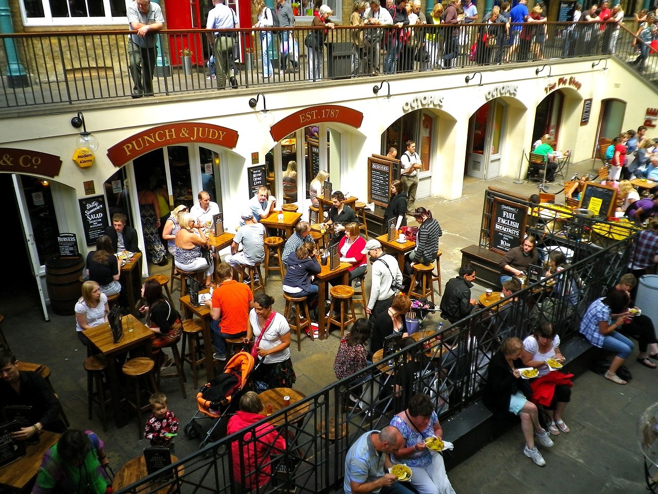 Busy outdoor pub scene at Covent Garden London with people dining and drinking