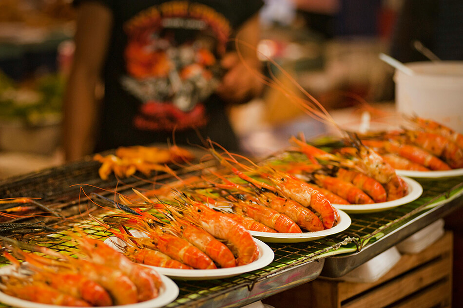 Grilled prawns served at a street food market in Thailand during the Christmas holiday season
