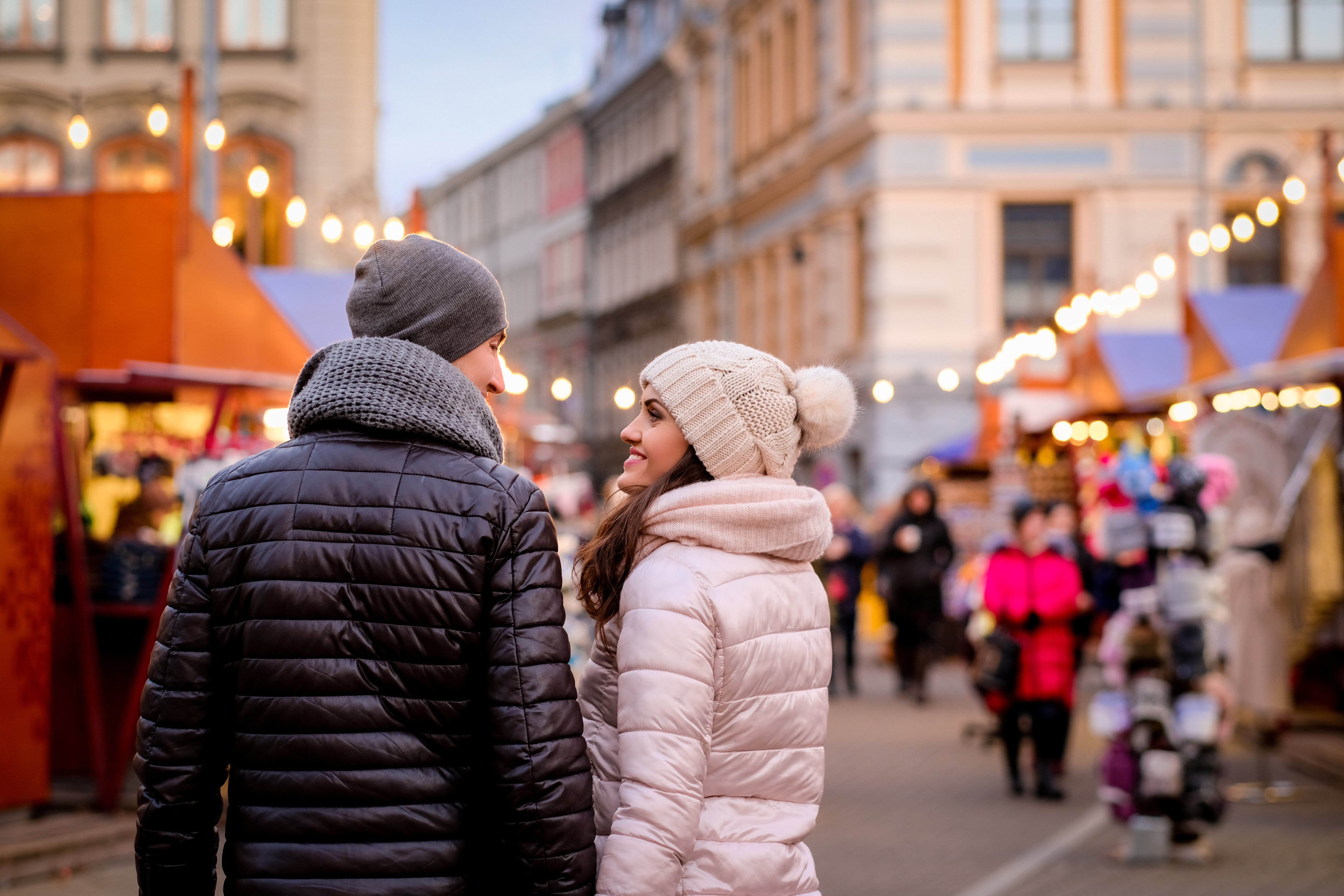 Travellers visiting an outdoor market in Italy during winter